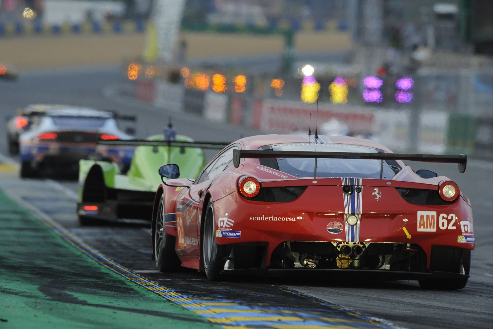 Rear view of a red #62 GT race car on track
